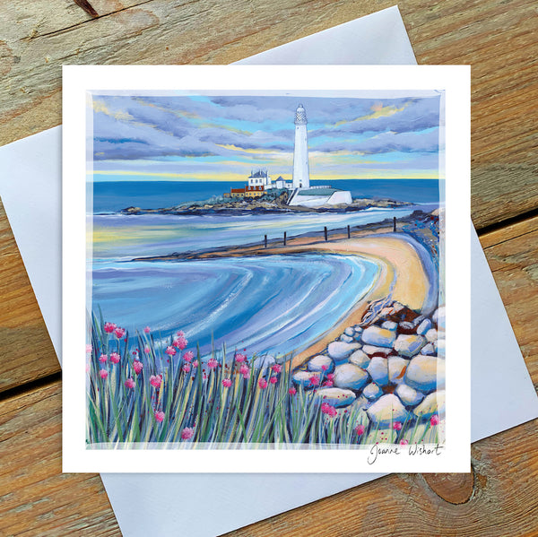 A greetings card of St Marys Island with soft blue tones and pops of pink flowers in the foreground. 