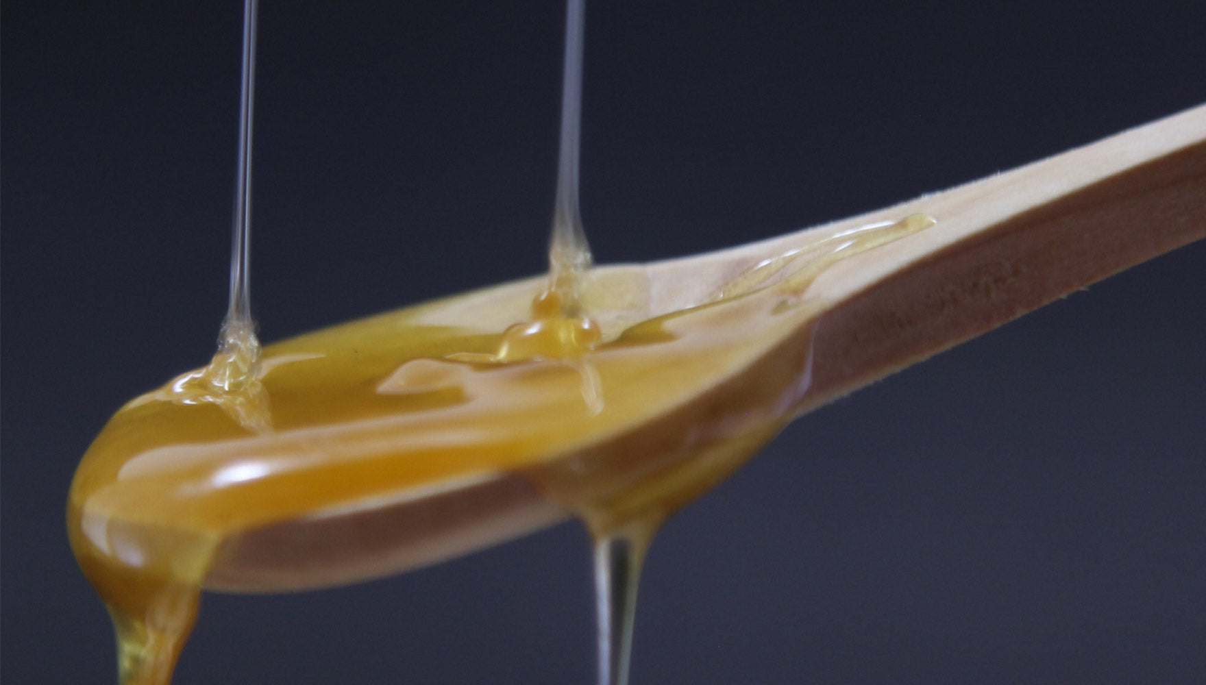 Honey poured in a spoon