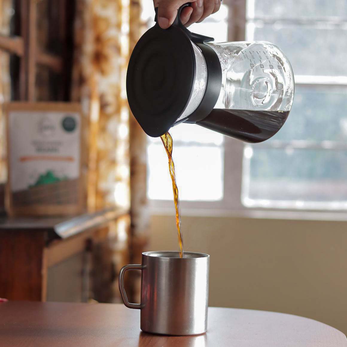 black coffee pouring into a cup