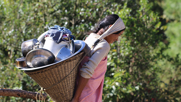 woman farmer carrying water