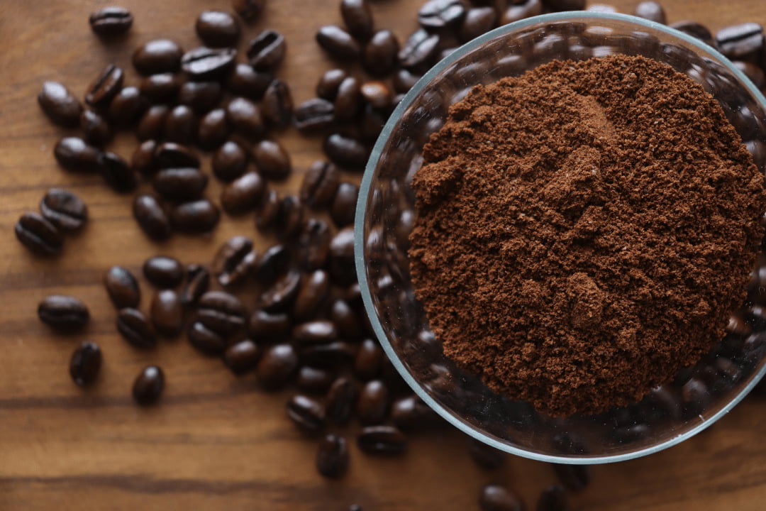 ground black coffee and coffee beans