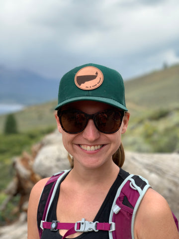 Sydney wearing the On A Limb Apparel trucker hat near Silverthorne CO