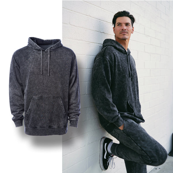 a man leaning against a wall wearing a mineral wash hoodie with a mannequin hoodie image with a drop shadow over the top