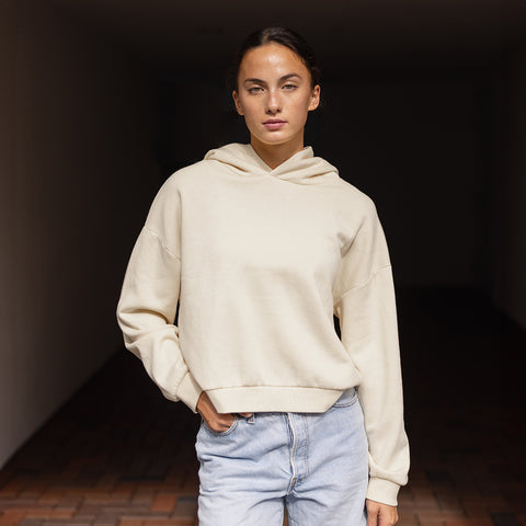 women wearing a white hoodie standing in front of a tunnel