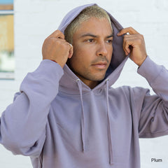 man wearing a purple "plum" colored sweatshirt with the hood up and his hands holding the sides of the hood