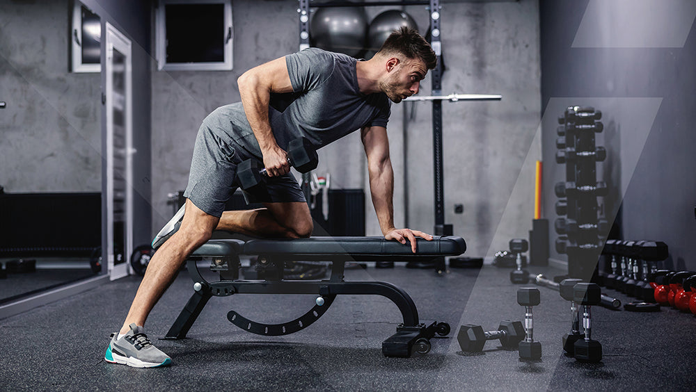 Person working out in a gym to maintain fitness goals year-round - New Year fitness resolution