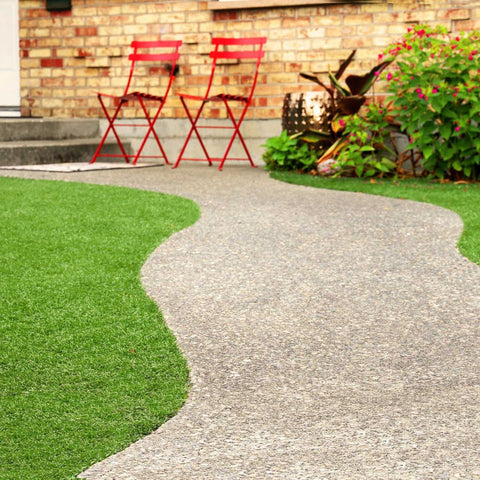 a pathed path through a yard up to chairs and steps