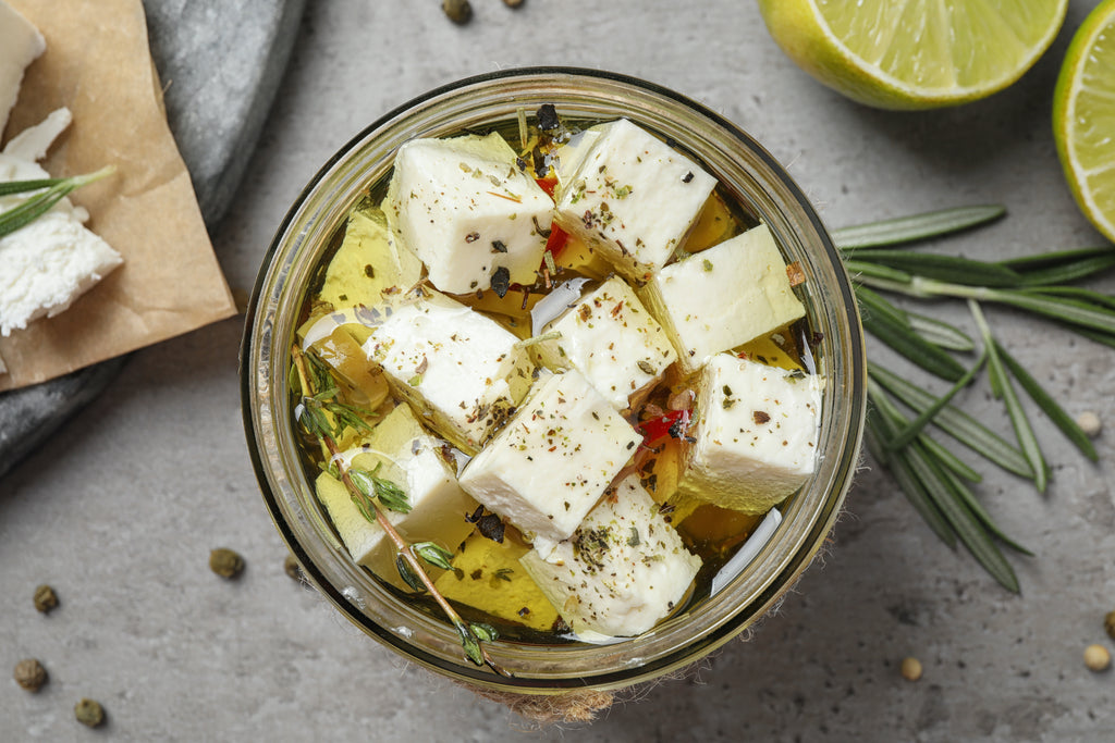 marinated goat cheese in a jar with spices and Pantry evoo