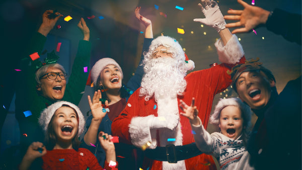 Santa and his party guests having fun during their gift exchange holiday party.