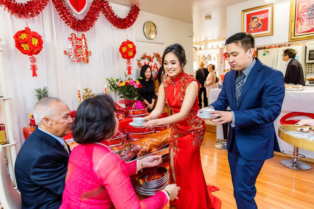 Couple serving tea ceremony tea to elders at wedding banquet