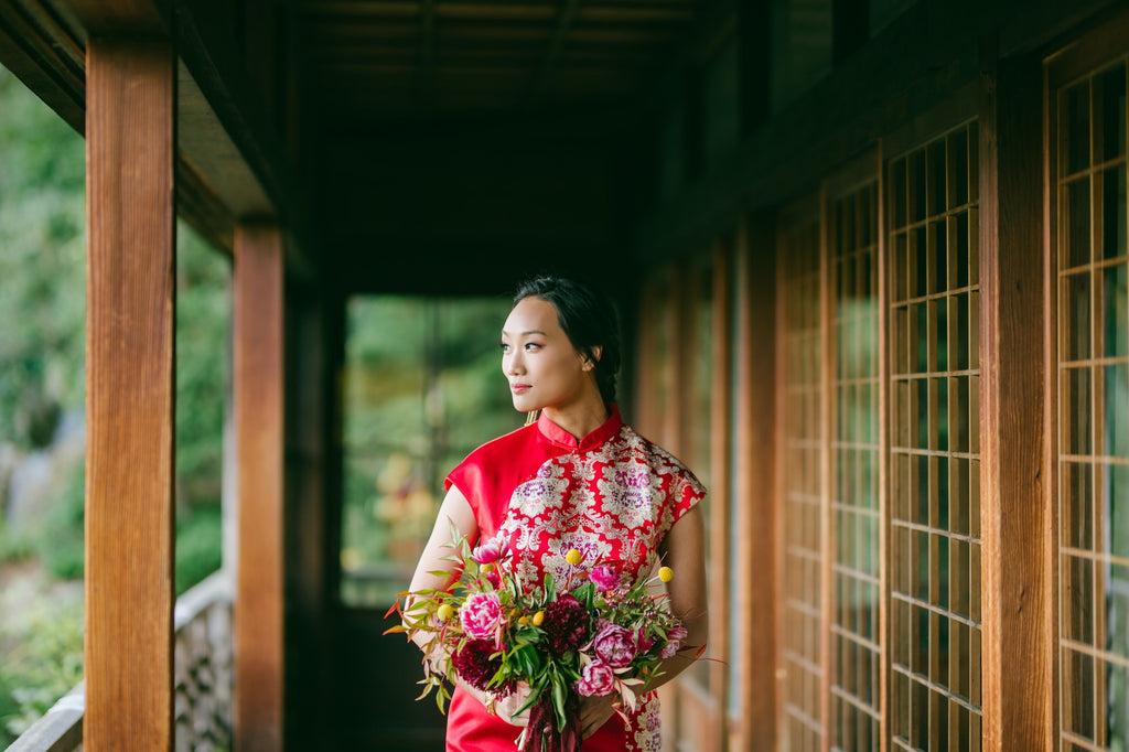 A Chinese bride in a beautiful red Cheongsam wedding dress.