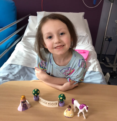 Evie smiling aged 6 on Oncology Ward in Leeds General Infirmary