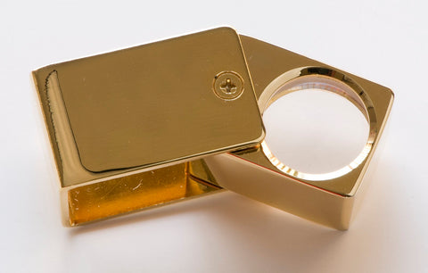 A jeweler's loupe and other tools of the trade are essential when buying estate pieces