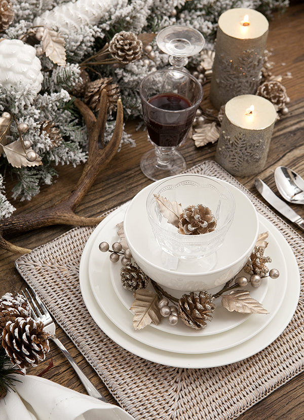 Gold pinecones, glassware & silver cutlery.