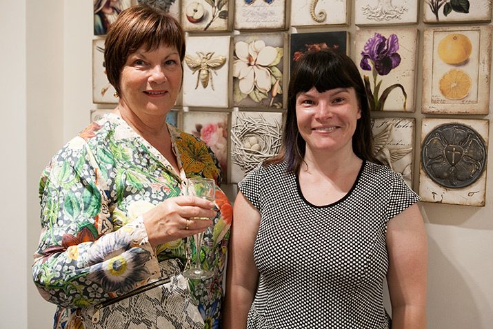 Mother and daughter in front of Sid Dickens Memory Blocks.