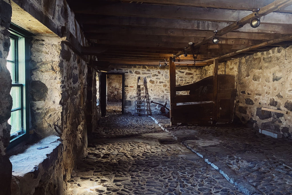 a cobbled old stone stable, waiting to be filled with whisky casks