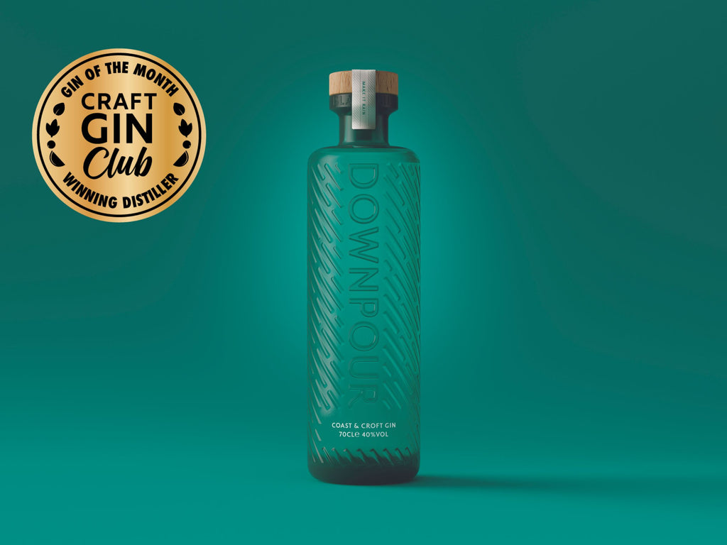 Downpour Coast and Croft Gin, turquoise embossed bottle on a glowing turquoise background. A gold medal reading 'craft gin club' sits on the image.