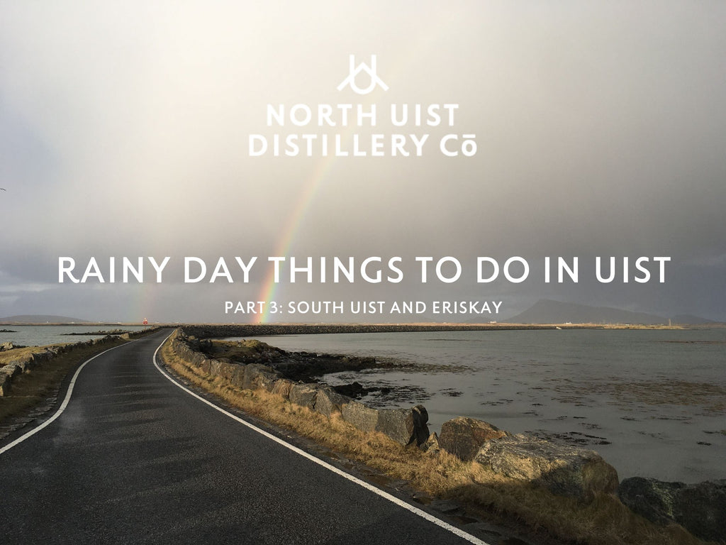 A rainy view out over a causeway, with a rainbow emerging in the distance. The words 'rainy day things to do in uist, part 3, south uist and eriskay' and the North Uist Distillery logo are imposed over the top. 