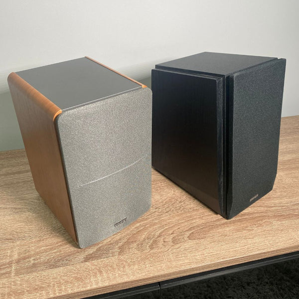 Edifier R1280DB in wood next to an Edifier R1700BT in black