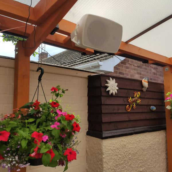 White Adastra BH6 Outdoor Speaker Mounted Under Garden Pergola With Roof