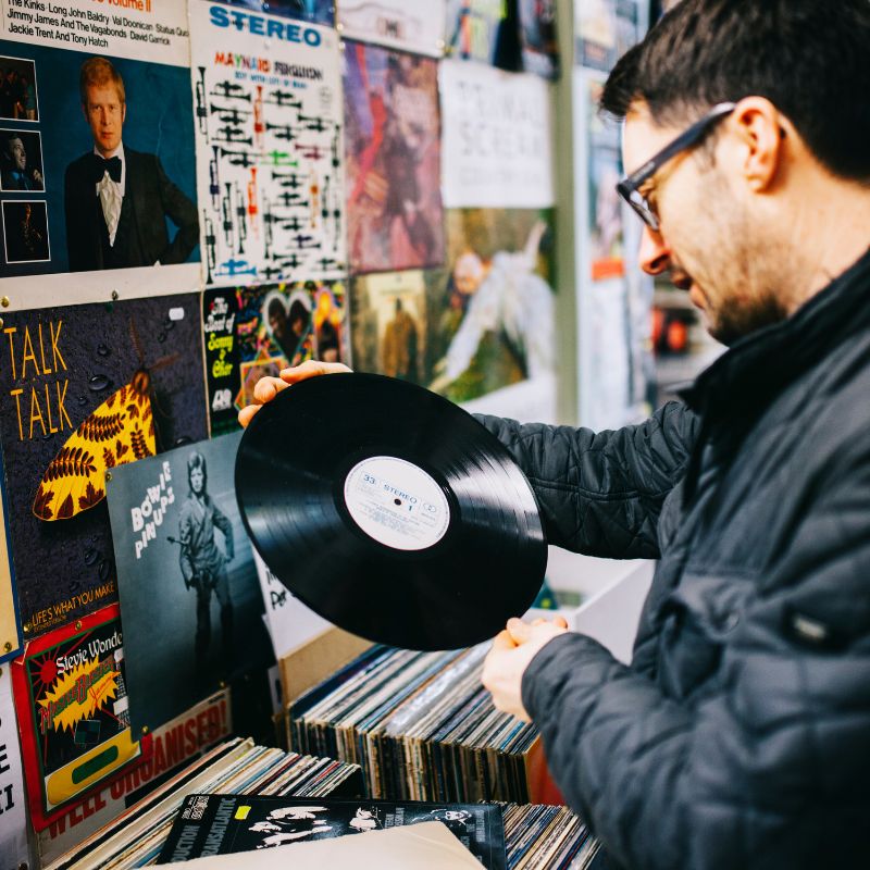 Man Holding Vinyl Record By The Edges