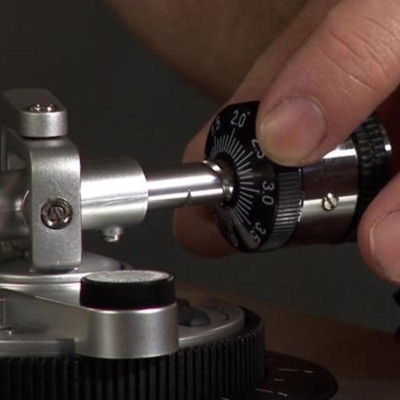 Man Adjusting Counterweight Of Record Player