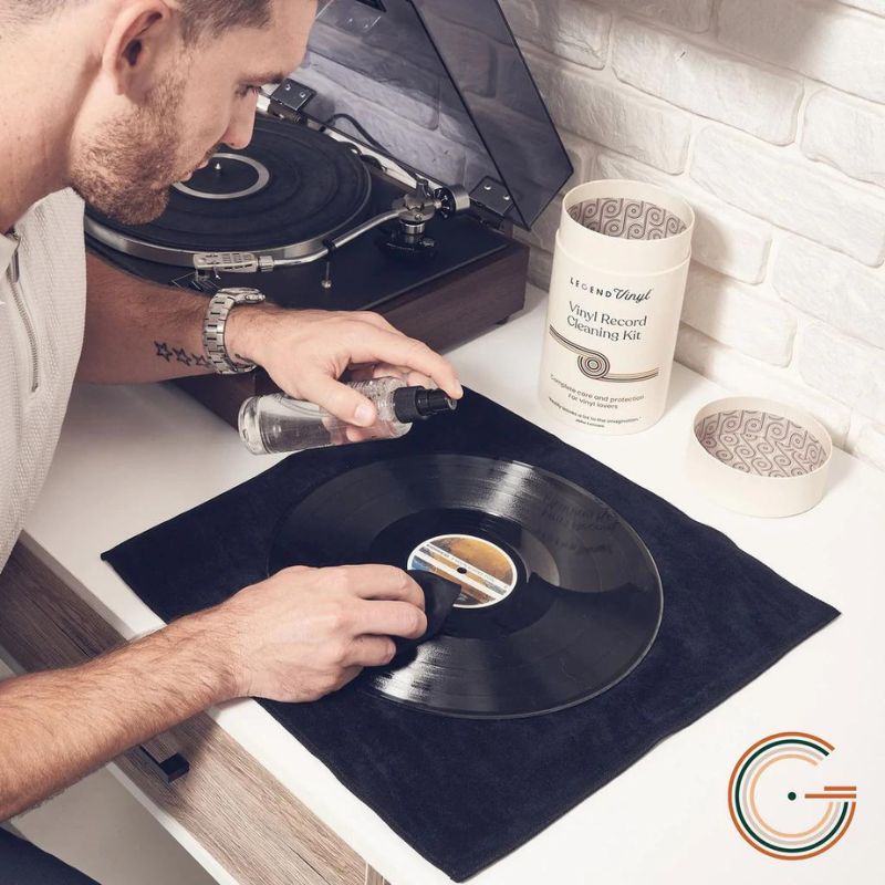 Man Cleaning Vinyl Record With Cloth