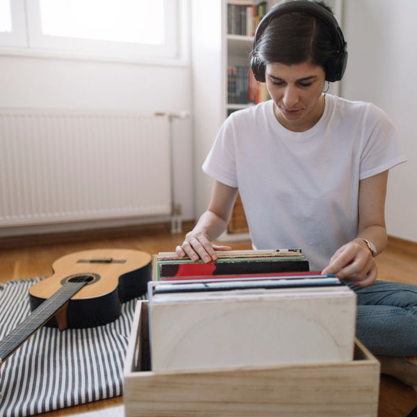Lady Wearing Headphones Browsing Through Vinyl Record Collection