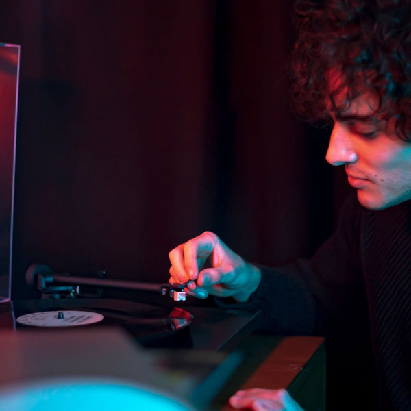 Man Placing Needle Onto Vinyl Record