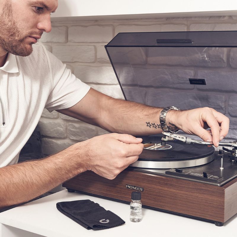 Man Cleaning Record Player Stylus