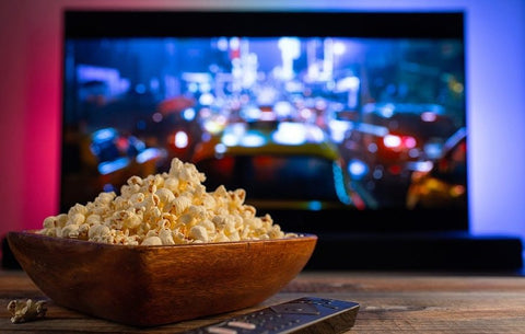 Close up image of popcorn and TV screen