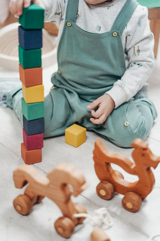 Toddler playing on an area rug