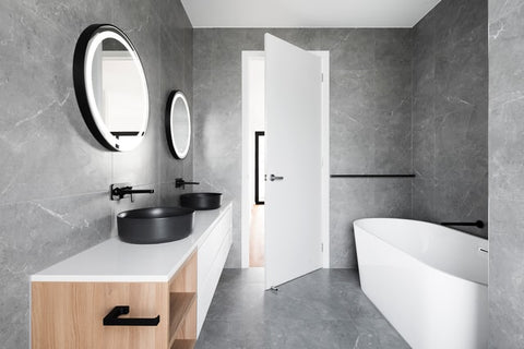 grey bathroom with matte black sinks and faucets