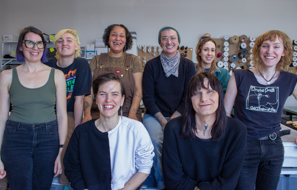 Origami Customs team photo of the 8 people who sew your custom clothing