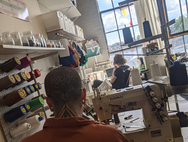 Rae working in the Origami Customs studio making custom handmade underwear in Montreal, Canada