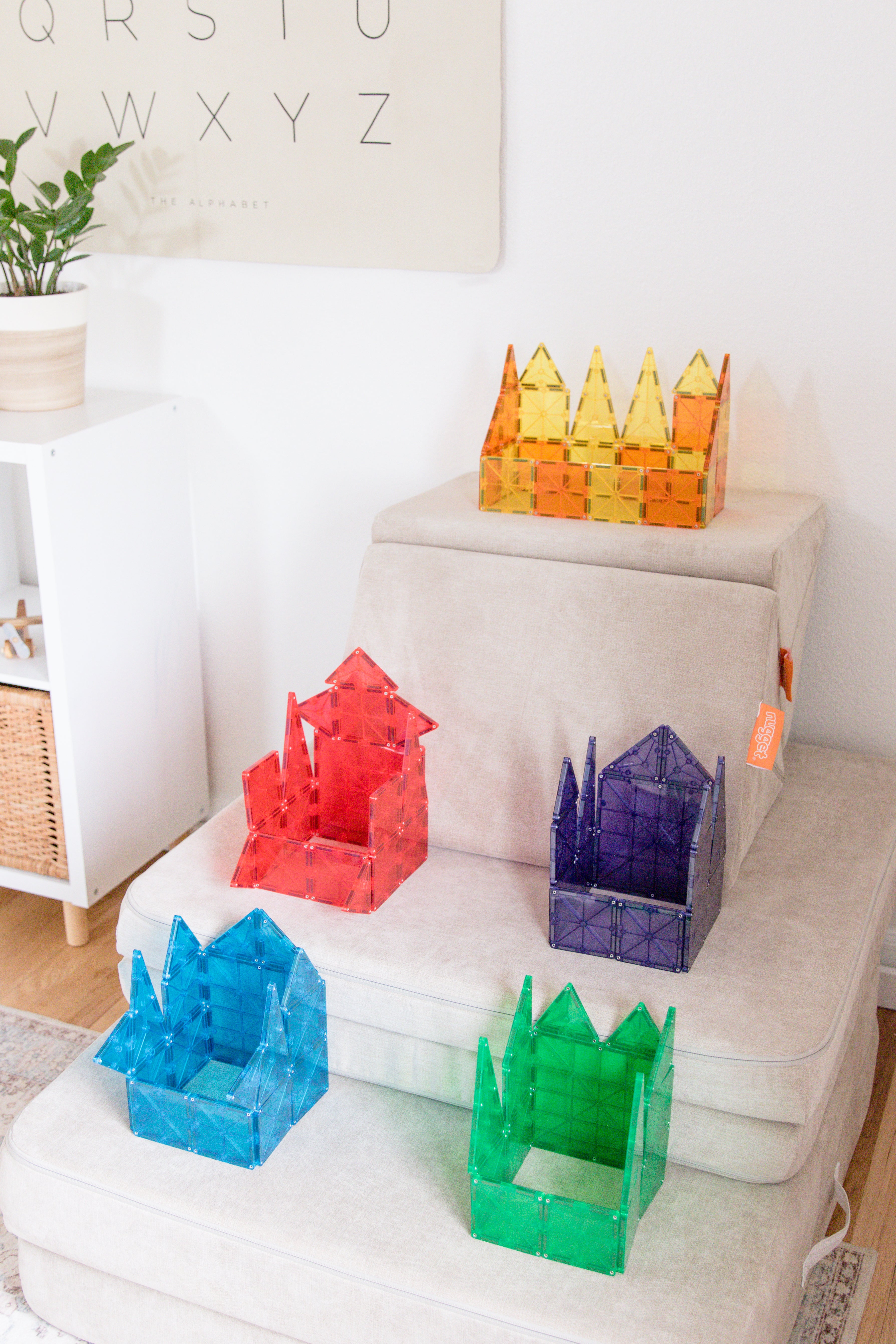 Boxes built out of Magna-tiles placed on top of the various stair levels of the Nugget