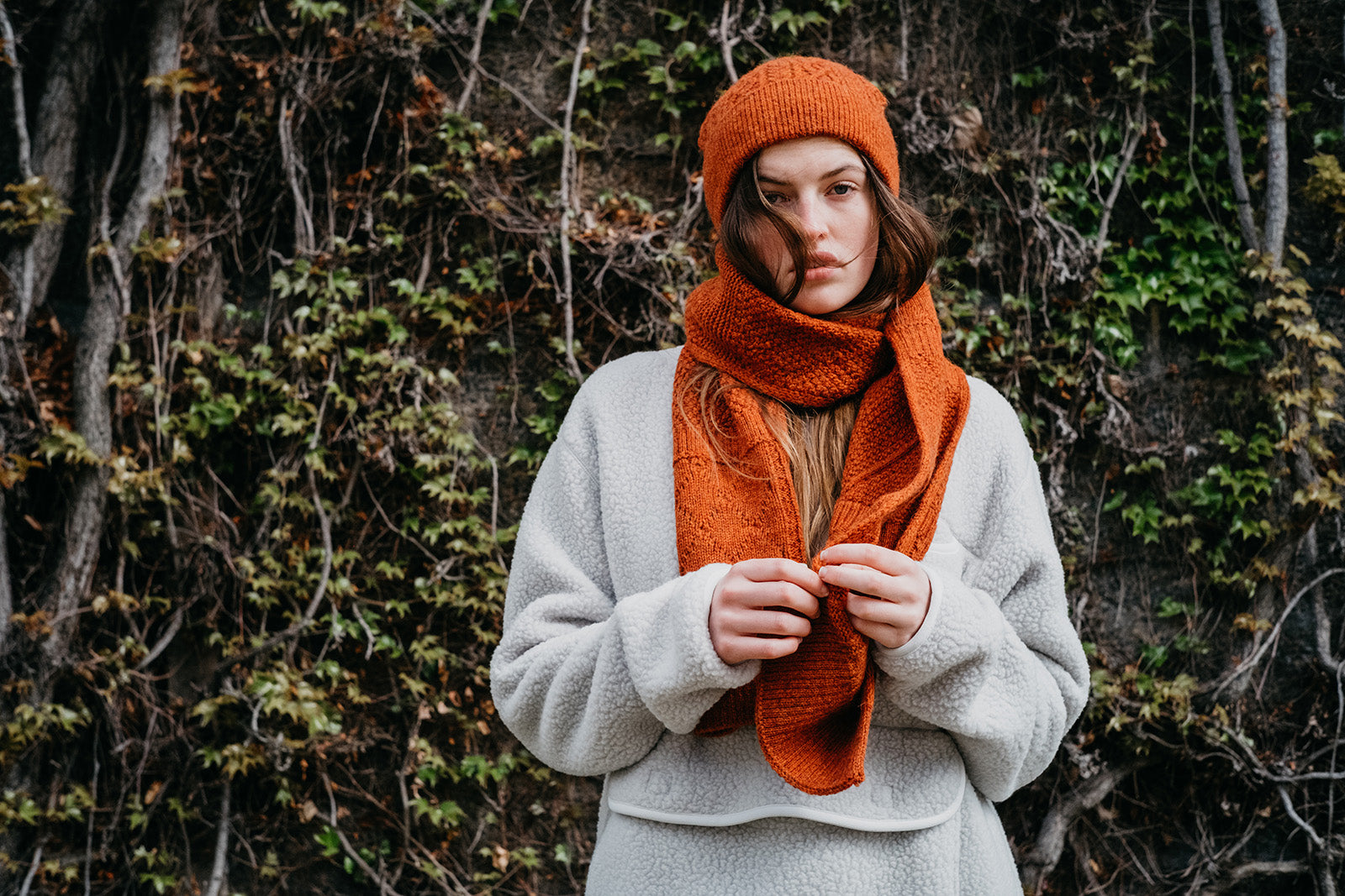 A British female model wearing Snow Peak Apparel AW21 Thermal fleece pullover and alpaca knit hat and scarf