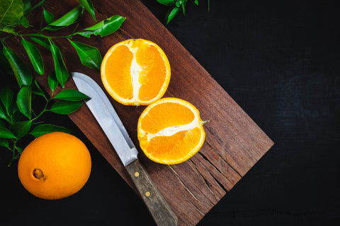 Freshly cut orange fruit on a wooden cutting board - InterPlexus Blog
