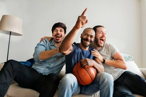 Male Friends cheering sport league together