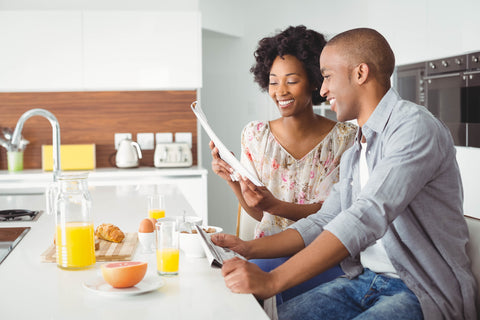 Smiling couple reading and eating breakfast together - InterPlexus Blog