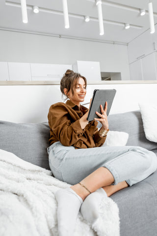 Woman with a tablet on the couch at home.jpg