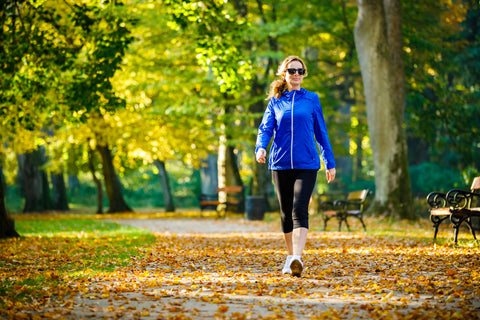 Healthy Woman Walking Amongst the Fall Leaves - Optimal sIgA Production and Immune Function