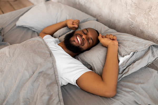 Man with a Healthy Gut Microbiome Waking Up with Tons of Energy after a Night of Restful Restorative Deep Sleep