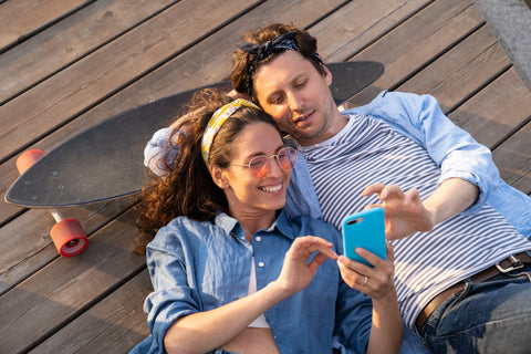 Healthy Fertile Couple with Optimal Salivary Progesterone Levels Relaxing on Boardwalk with Skateboard on a Warm Summer Day