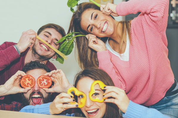 Healthy Happy Friends Preparing for a Fun Meal with Organic Vegetables