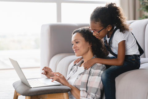 Mom freelancer trying to concentrate on distant remote work while small daughter disturbing her