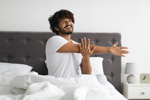 Young Healthy Man Waking Up Refreshed and with an Abundance of Energy After a Night of Healthy Deep Sleep