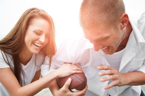 Active Happy Couple With Optimal Free Testosterone Levels Playing Football