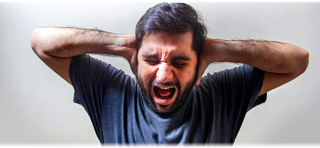 Image depicting a person screaming in frustration or fear against a blurred background.