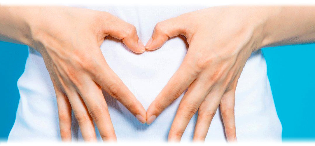 An image portraying a person holding their hands in front of their stomach in the shape of a  heart, highlighting a healthy body. 